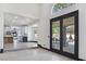 Bright living room featuring light floors, and views to the kitchen and outdoor patio at 8112 Golfers Oasis Dr, Las Vegas, NV 89149