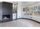 Bright living room with fireplace, wet bar, and curved windows at 8112 Golfers Oasis Dr, Las Vegas, NV 89149