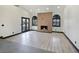 Light and airy living room with modern fireplace, wood accent wall, and arched shuttered windows at 8112 Golfers Oasis Dr, Las Vegas, NV 89149