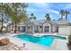 Sparkling pool with Baja shelf and covered patio offers a perfect space for outdoor entertaining at 8112 Golfers Oasis Dr, Las Vegas, NV 89149