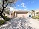 Charming single-story home with a tile roof, desert landscaping, and a brick driveway at 8161 Cane Creek Mill Ct, Las Vegas, NV 89131