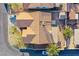 Birds-eye view of home with tile roof, two palm trees, and surrounding landscaping at 819 Teal Wing Way, Henderson, NV 89002