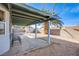 Cozy covered back patio with a mature palm tree and block wall perimeter at 819 Teal Wing Way, Henderson, NV 89002