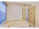 Bathroom featuring soaking tub, a separate shower, and a window at 819 Teal Wing Way, Henderson, NV 89002