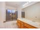 Bright bathroom featuring double sinks, vanity, tub, and shower combo at 819 Teal Wing Way, Henderson, NV 89002