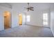 Primary bedroom with natural light, ceiling fan and adjacent bathroom and closet at 819 Teal Wing Way, Henderson, NV 89002
