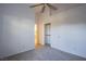 A neutral carpeted bedroom with closet and view to the bathroom at 819 Teal Wing Way, Henderson, NV 89002