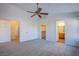 Spacious primary bedroom with ceiling fan and multiple closets and doorways at 819 Teal Wing Way, Henderson, NV 89002