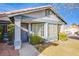 Inviting front porch with a decorative storm door, manicured bushes, and manicured lawn at 819 Teal Wing Way, Henderson, NV 89002