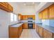 Bright kitchen featuring wooden cabinets, modern appliances, and tile flooring at 819 Teal Wing Way, Henderson, NV 89002