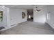 Open living space with carpet, a glimpse of a fireplace, and access to other rooms at 819 Teal Wing Way, Henderson, NV 89002