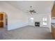 Open-concept living room with fireplace, neutral carpet, and access to the backyard at 819 Teal Wing Way, Henderson, NV 89002