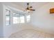 Bright, open living room with large windows, a ceiling fan, and neutral paint at 819 Teal Wing Way, Henderson, NV 89002