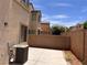Small backyard patio area with block wall, air conditioner and view of adjacent houses at 8301 Strawberry Spring St, Las Vegas, NV 89143