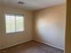 Cozy carpeted bedroom with window and neutral walls, offering a blank canvas at 8301 Strawberry Spring St, Las Vegas, NV 89143