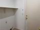 Laundry room with overhead shelving and utility hookups at 8301 Strawberry Spring St, Las Vegas, NV 89143
