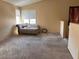 Large carpeted living room with natural light from two windows, awaiting personal touches at 8301 Strawberry Spring St, Las Vegas, NV 89143