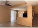 Spacious living room with a ceiling fan and staircase, ready for customization at 8301 Strawberry Spring St, Las Vegas, NV 89143