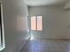 Bright living room featuring tiled flooring and ample natural light from multiple windows at 8301 Strawberry Spring St, Las Vegas, NV 89143