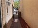 Paver walkway between buildings with red mulch and lamp, leading to open area with tree at 8301 Strawberry Spring St, Las Vegas, NV 89143