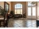 Grand foyer showcasing soaring ceilings, tile flooring, a staircase, and decorative chandelier at 9012 Alpine Peaks Ave, Las Vegas, NV 89147