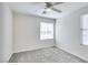 Bedroom with neutral carpet, a ceiling fan, and two windows providing natural light at 9092 Sosa Creek Ave, Las Vegas, NV 89149