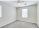 Bedroom with neutral carpet, a ceiling fan, and lots of natural light from two windows at 9092 Sosa Creek Ave, Las Vegas, NV 89149