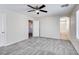 Bedroom boasts neutral carpet, a ceiling fan, and entry to a bathroom offering an ensuite arrangement at 9092 Sosa Creek Ave, Las Vegas, NV 89149