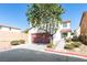 Charming two-story home with a red-brown garage door and low maintenance desert landscaping at 9092 Sosa Creek Ave, Las Vegas, NV 89149