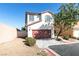 Charming two-story home with a red-brown garage door and low maintenance desert landscaping at 9092 Sosa Creek Ave, Las Vegas, NV 89149