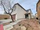 Two-story home with a two-car garage, stucco exterior, and concrete stairs leading to the front entrance at 9092 Sosa Creek Ave, Las Vegas, NV 89149