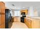 Modern kitchen with stainless appliances, light wood cabinets, and recessed lighting at 9092 Sosa Creek Ave, Las Vegas, NV 89149