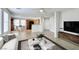 Bright, open living room and kitchen with tile floors, modern decor, and stainless appliances at 9092 Sosa Creek Ave, Las Vegas, NV 89149