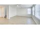 Bright living room featuring tile flooring, white walls, and natural light from two large windows at 9092 Sosa Creek Ave, Las Vegas, NV 89149