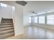 Spacious living room with tile flooring, many windows, and a staircase at 9092 Sosa Creek Ave, Las Vegas, NV 89149
