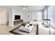 Bright, open living room features tile floors, modern decor, and a comfortable white sectional sofa at 9092 Sosa Creek Ave, Las Vegas, NV 89149