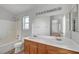 A bathroom featuring dual sinks, ample vanity storage, and a shower-tub combo at 9177 Bucksprings Dr, Las Vegas, NV 89129