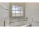 Bright bathroom featuring a tub with tiled surround and a window for natural light at , Las Vegas, NV 89130
