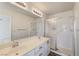 Bathroom with double sink vanity, ample lighting, and a walk-in shower with updated fixtures at , Las Vegas, NV 89130