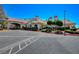 Exterior of a beautiful clubhouse with covered entry, desert landscaping, and ample parking at , Las Vegas, NV 89130