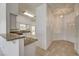 Bright entryway leading to kitchen with breakfast bar and white cabinets at , Las Vegas, NV 89130