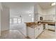 Kitchen featuring granite countertops, white cabinets, and tile floors that open into the carpeted living room at , Las Vegas, NV 89130