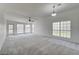 Spacious carpeted living room with ample natural light from the multiple large windows at , Las Vegas, NV 89130