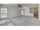 Spacious carpeted living room with ample natural light from the multiple large windows at , Las Vegas, NV 89130