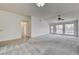 Spacious carpeted living room with ample natural light from the multiple large windows at , Las Vegas, NV 89130