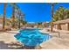 Tranquil community pool area with palm trees, lounge chairs, and clear blue water at 10199 Rising Tree St, Las Vegas, NV 89183