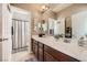 Bright bathroom featuring a double sink vanity with decorative elements and tiled flooring at 12277 Bluebird Canyon Pl, Las Vegas, NV 89138