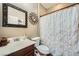Cozy bathroom features a decorative mirror and shower with curtain at 12277 Bluebird Canyon Pl, Las Vegas, NV 89138