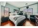Stylish bedroom featuring hardwood floors, and a desk area with a Raiders-themed accent wall at 12277 Bluebird Canyon Pl, Las Vegas, NV 89138