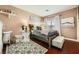 Comfortable bedroom featuring hardwood floors, a cozy rug, and soft lighting at 12277 Bluebird Canyon Pl, Las Vegas, NV 89138